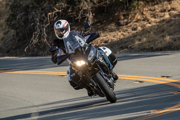 How do dipped headlights enhance motorcycle visibility