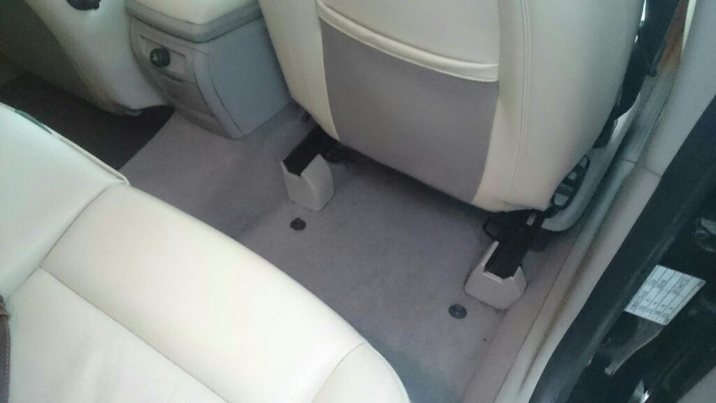 What are the common causes of a wet back footwell in a car